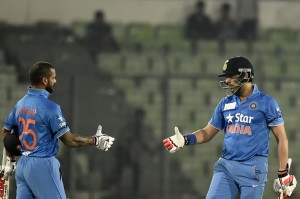 Indian cricketer Yuvraj Singh (R) shakes hands with teammate Shikhar Dhawan (L) as they celebrates after winning the Asia Cup T20 cricket tournament match between United Arab Emirates and India at The Sher-e-Bangla National Cricket Stadium in Dhaka on March 3, 2016.  / AFP / MUNIR UZ ZAMAN        (Photo credit should read MUNIR UZ ZAMAN/AFP/Getty Images)