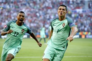 epa05384000 Cristiano Ronaldo of Portugal (R) celebrates scoring the 2-2 with Nani during the UEFA EURO 2016 group F preliminary round match between Hungary and Portugal at Stade de Lyon in Lyon, France, 22 June 2016. (RESTRICTIONS APPLY: For editorial news reporting purposes only. Not used for commercial or marketing purposes without prior written approval of UEFA. Images must appear as still images and must not emulate match action video footage. Photographs published in online publications (whether via the Internet or otherwise) shall have an interval of at least 20 seconds between the posting.)  EPA/ROBERT GHEMENT   EDITORIAL USE ONLY